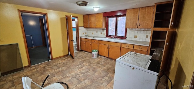 147 Montana Ave, Buffalo, NY 14211 - kitchen featuring brown cabinetry, light countertops, open shelves, and decorative backsplash