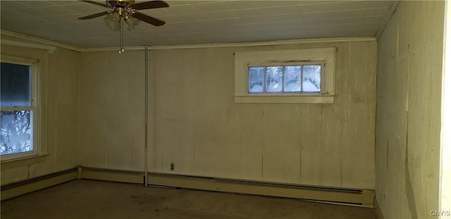 empty room featuring ceiling fan, ornamental molding, and baseboard heating