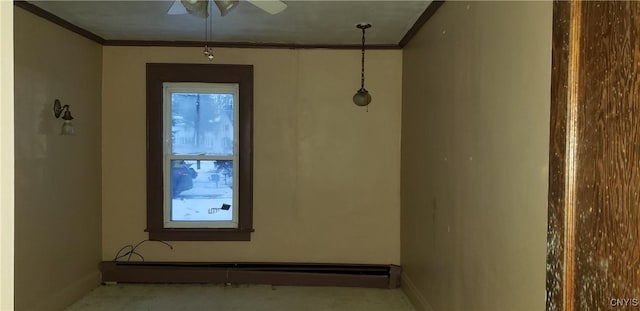 empty room featuring a baseboard heating unit and ornamental molding