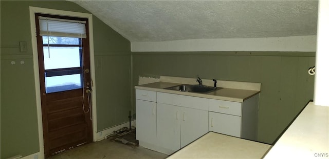 clothes washing area featuring sink and a textured ceiling