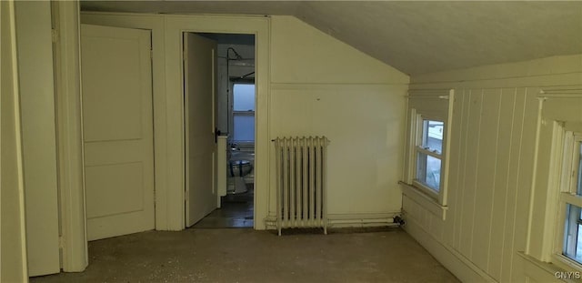 bonus room featuring radiator heating unit and lofted ceiling