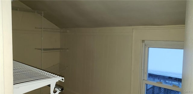 walk in closet featuring lofted ceiling