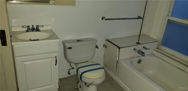 bathroom featuring toilet, a bathing tub, and vanity