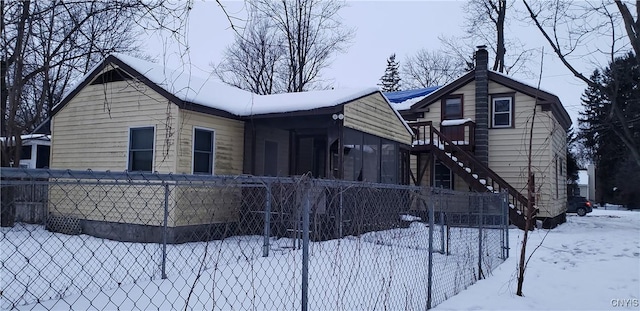 view of snow covered rear of property