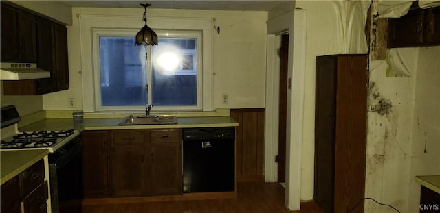 kitchen featuring gas stove, black dishwasher, dark hardwood / wood-style flooring, hanging light fixtures, and ventilation hood