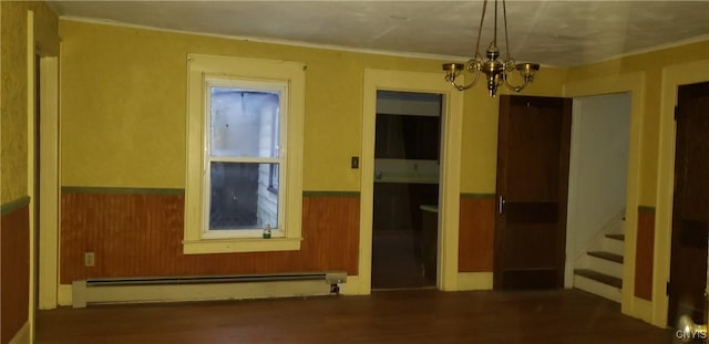 unfurnished room featuring a baseboard heating unit, dark hardwood / wood-style flooring, and an inviting chandelier