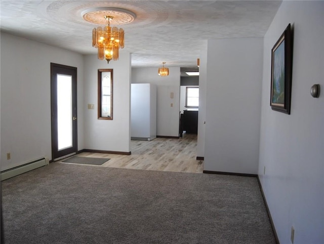 516 N Tionesta Ave, Kane Boro, PA 16735 - spare room with a chandelier, carpet floors, baseboard heating, and a textured ceiling