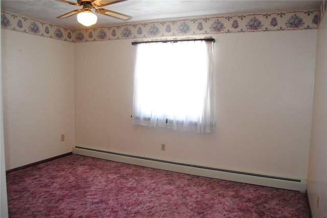 carpeted spare room featuring ceiling fan, baseboard heating, and plenty of natural light