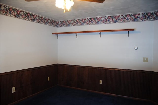 516 N Tionesta Ave, Kane Boro, PA 16735 - empty room with a ceiling fan, a wainscoted wall, and wood walls