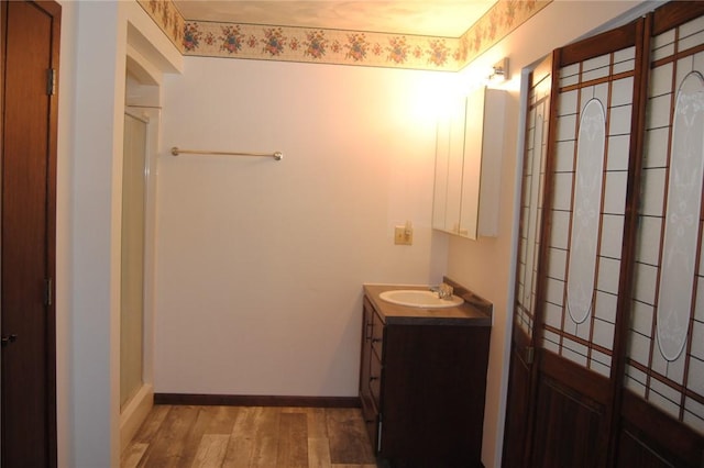 bathroom with hardwood / wood-style floors and vanity