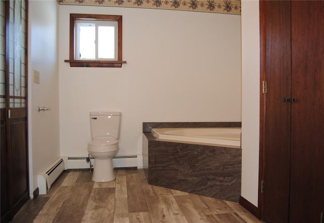 bathroom with wood-type flooring, a baseboard radiator, toilet, and tiled tub