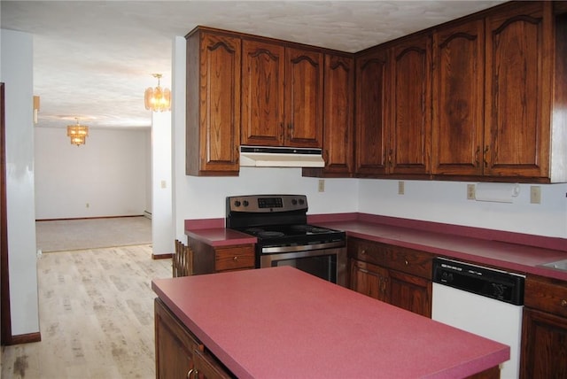 kitchen with pendant lighting, white dishwasher, a textured ceiling, electric range, and light hardwood / wood-style floors