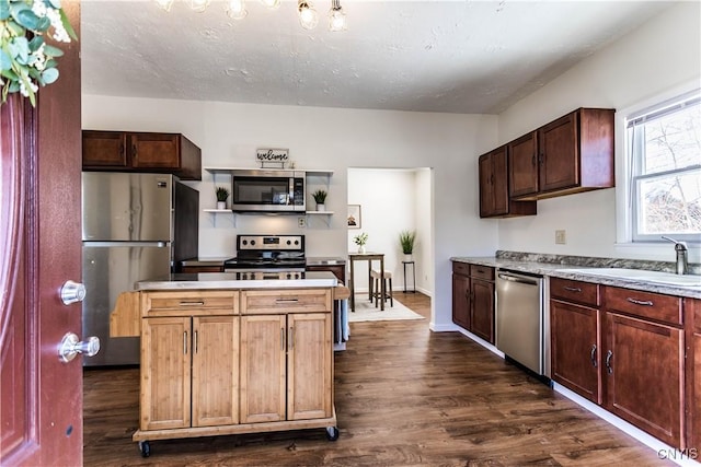 kitchen featuring sink, dark wood-type flooring, and appliances with stainless steel finishes