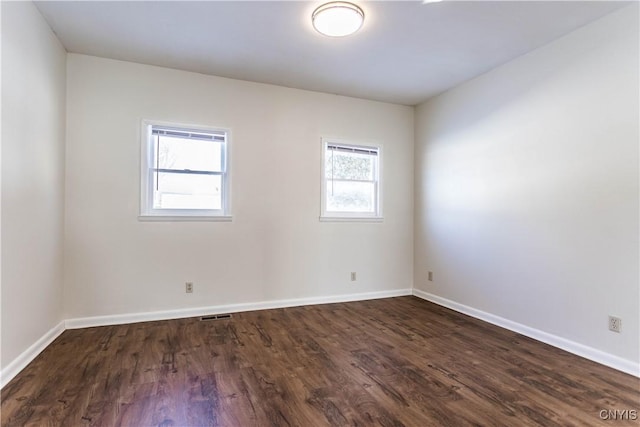 empty room with dark hardwood / wood-style floors