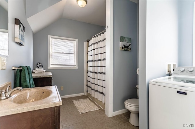 bathroom with toilet, washer / dryer, tile patterned floors, vanity, and lofted ceiling