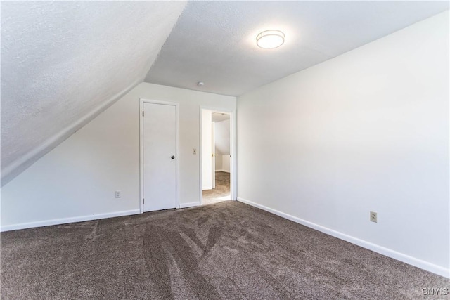 bonus room with carpet flooring, a textured ceiling, and lofted ceiling