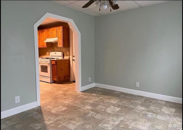 spare room featuring ceiling fan and a drop ceiling