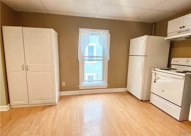 kitchen featuring white appliances, a drop ceiling, white cabinets, and light hardwood / wood-style floors