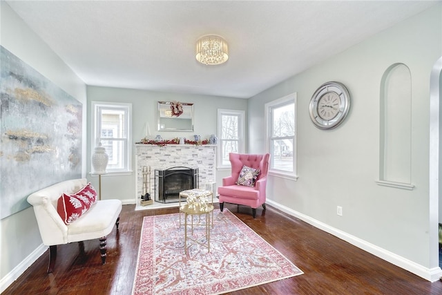 living area with a wealth of natural light and dark hardwood / wood-style floors