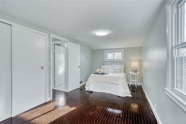 bedroom with hardwood / wood-style floors and a closet