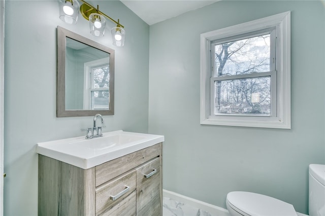 bathroom featuring toilet and vanity