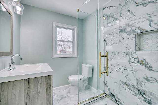 bathroom featuring a shower with door, toilet, and vanity