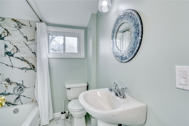 full bathroom with sink, shower / bath combo with shower curtain, and toilet