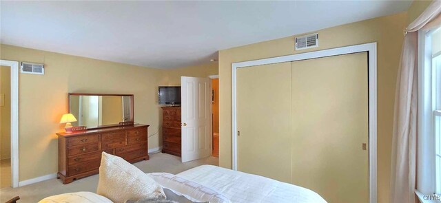 carpeted bedroom with a closet