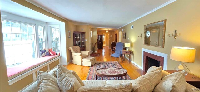 living room featuring light wood-type flooring and ornamental molding