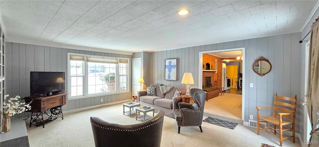 carpeted living room with a brick fireplace and ornamental molding