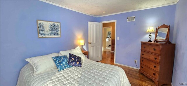 bedroom featuring crown molding and hardwood / wood-style flooring