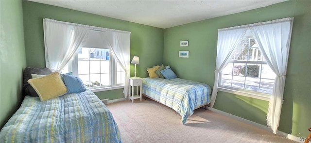 carpeted bedroom featuring multiple windows