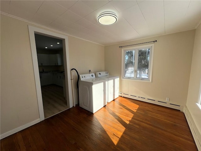 washroom with washing machine and dryer, dark hardwood / wood-style floors, crown molding, and baseboard heating