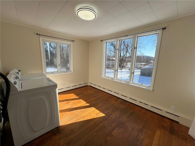 laundry area featuring a baseboard heating unit, a wealth of natural light, and dark wood-type flooring