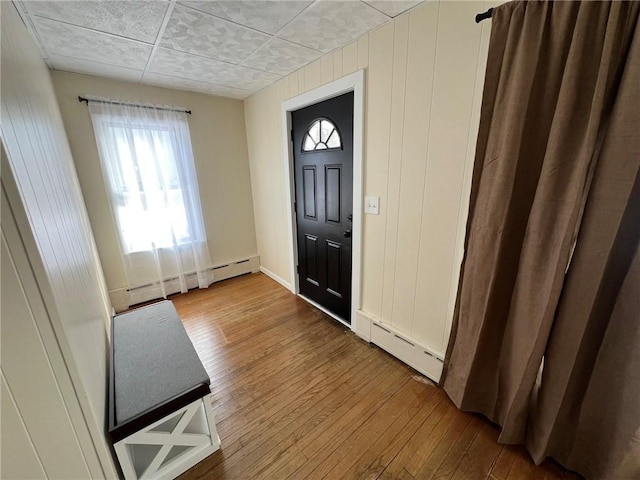 entrance foyer featuring a baseboard radiator and hardwood / wood-style floors