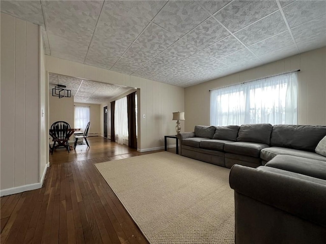 living room featuring a wealth of natural light and dark hardwood / wood-style flooring