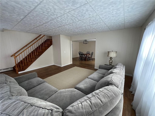 8074 State Route 90, Montezuma, NY 13040 - living room featuring stairs, wood finished floors, and baseboards