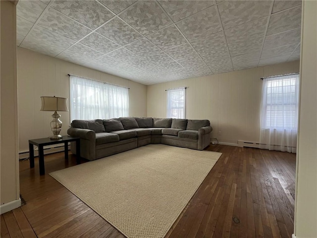 8074 State Route 90, Montezuma, NY 13040 - unfurnished living room featuring dark wood finished floors, baseboards, and a baseboard radiator
