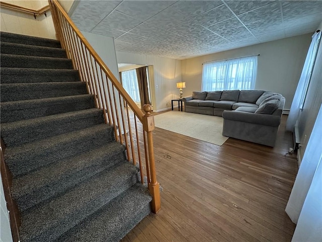 8074 State Route 90, Montezuma, NY 13040 - interior space featuring a paneled ceiling, baseboards, and hardwood / wood-style floors