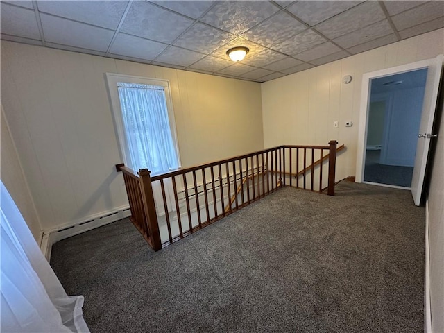 staircase featuring carpet floors, a drop ceiling, and baseboard heating