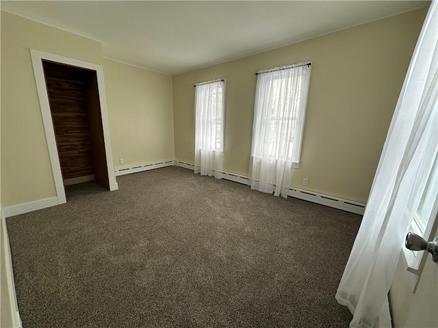 unfurnished bedroom with ornamental molding and dark colored carpet