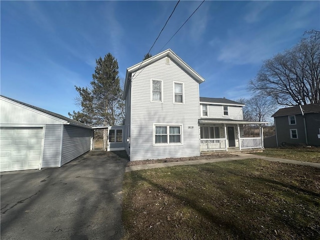 8074 State Route 90, Montezuma, NY 13040 - back of property featuring a porch, a garage, and aphalt driveway