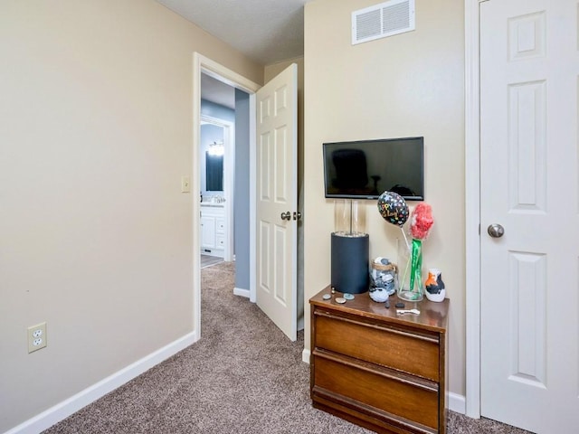 hall with light colored carpet