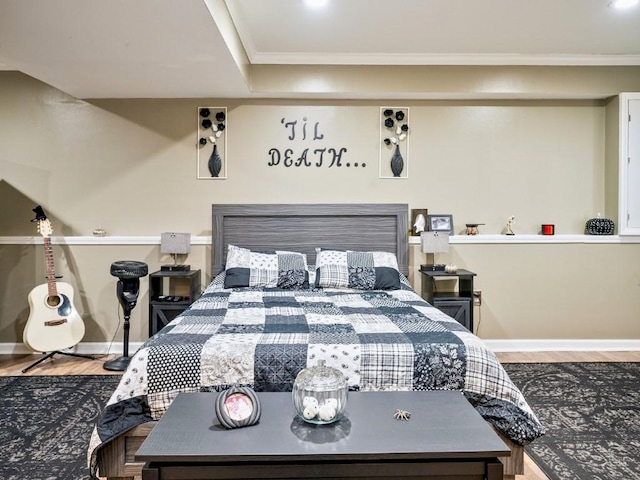 bedroom with hardwood / wood-style flooring and ornamental molding