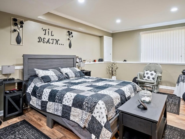 bedroom with wood-type flooring and crown molding