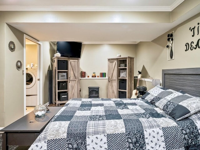 bedroom with crown molding, a wood stove, and washer / dryer