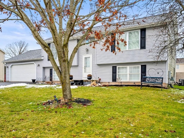 view of front of home featuring a garage and a front lawn