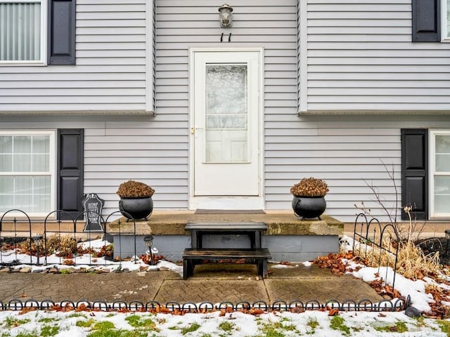 view of snow covered property entrance