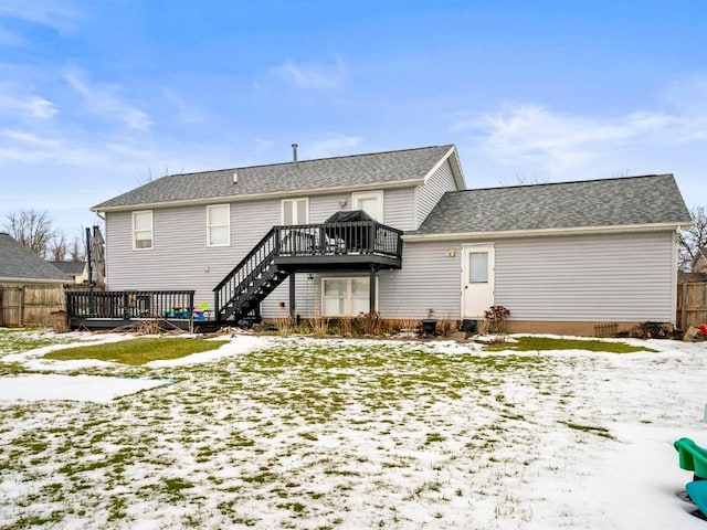 snow covered house featuring a deck