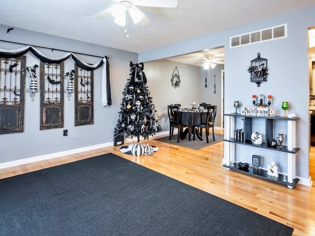 exercise room featuring hardwood / wood-style flooring and ceiling fan